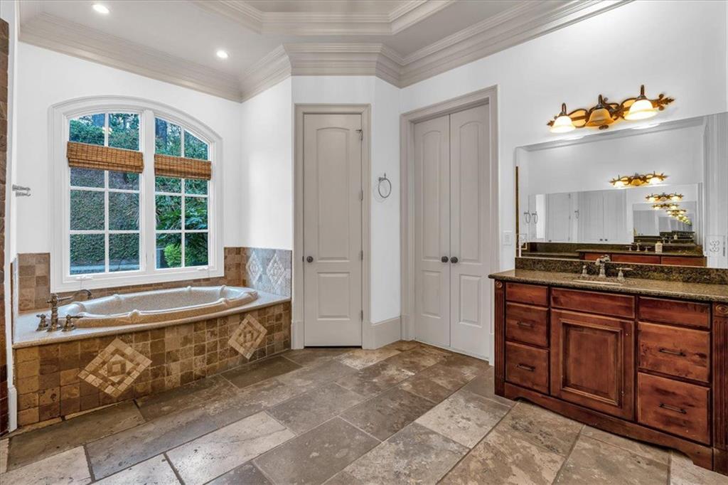 115 Mount Paran Ridge Atlanta, GA 30327 - Photo 64 of 85 a spacious bathroom with a granite countertop sink and a tub