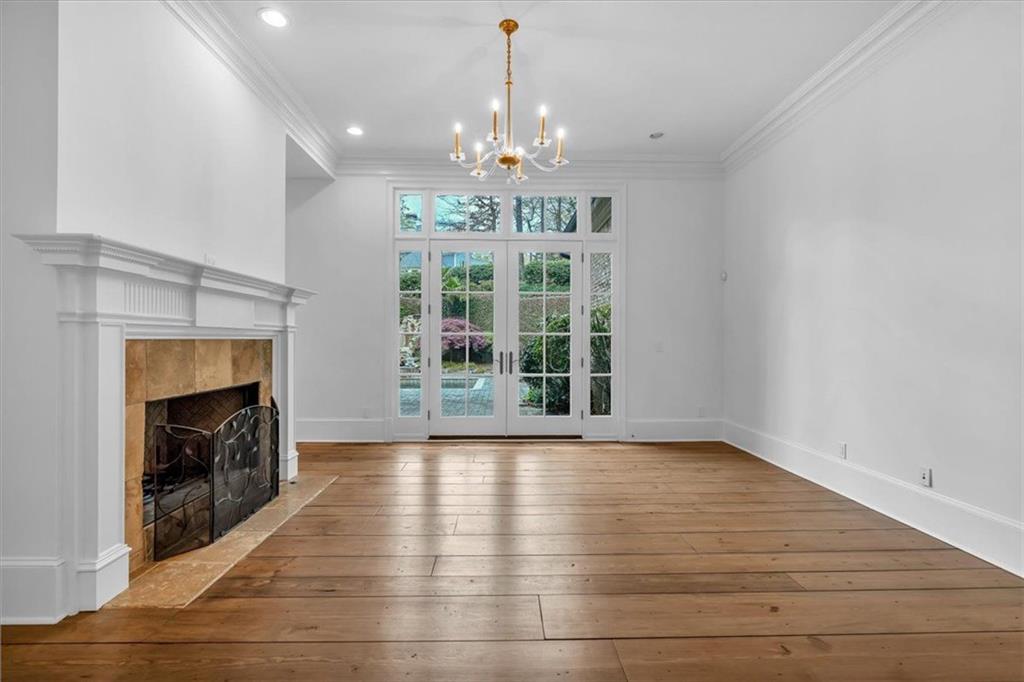115 Mount Paran Ridge Atlanta, GA 30327 - Photo 8 of 85 a view of an empty room with wooden floor fireplace and a window