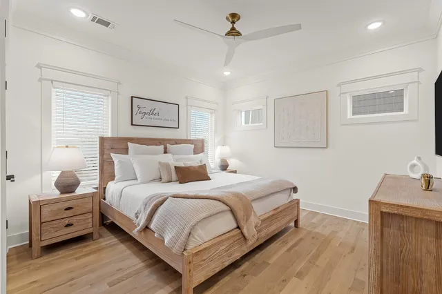a bedroom with a bed and wooden floor