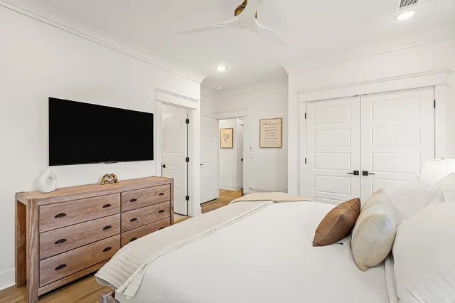 a bedroom with a bed and a flat screen tv