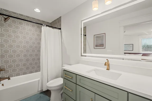 a bathroom with a sink a toilet and a bathtub