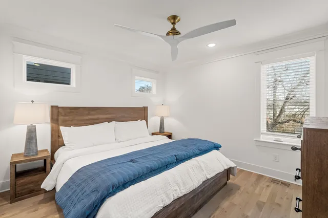 a bed sitting in a bedroom next to a window