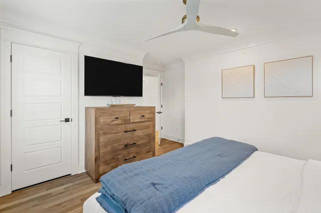 a bedroom with a bed and a flat screen tv