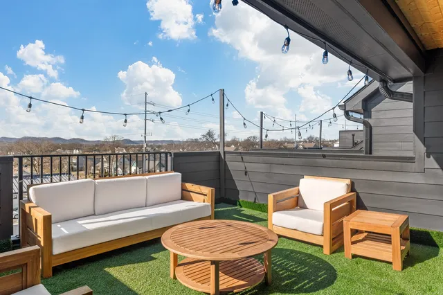 a outdoor living space with furniture and a fireplace