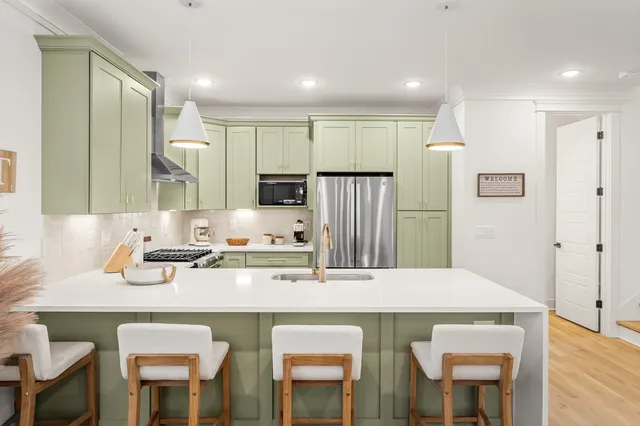 a kitchen with stainless steel appliances a sink stove and refrigerator