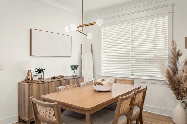 a view of a dining room that has a table and chairs in it