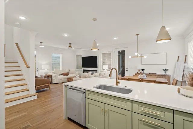 a kitchen with sink and view living room