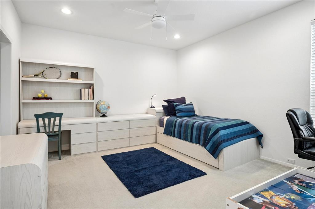 6419 Laurel Valley Road Dallas, TX 75248 - Photo 27 of 34 a bedroom with a bed and a bookshelf
