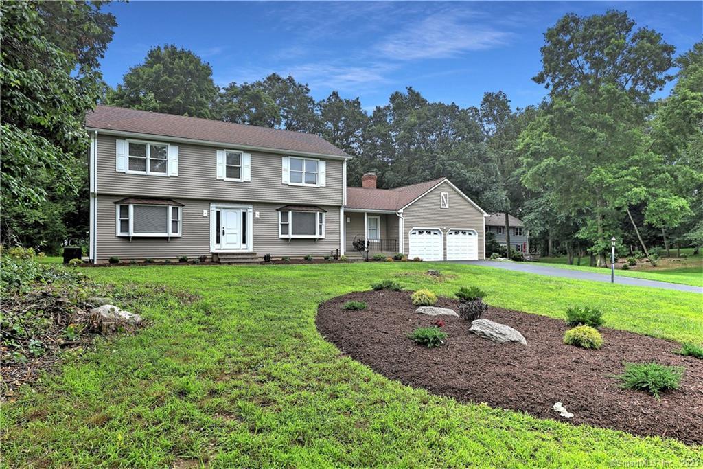 a front view of a house with a yard and garage