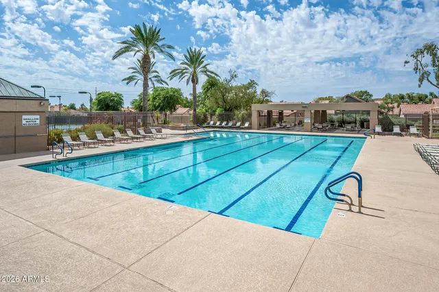 a view of swimming pool with outdoor seating and plants