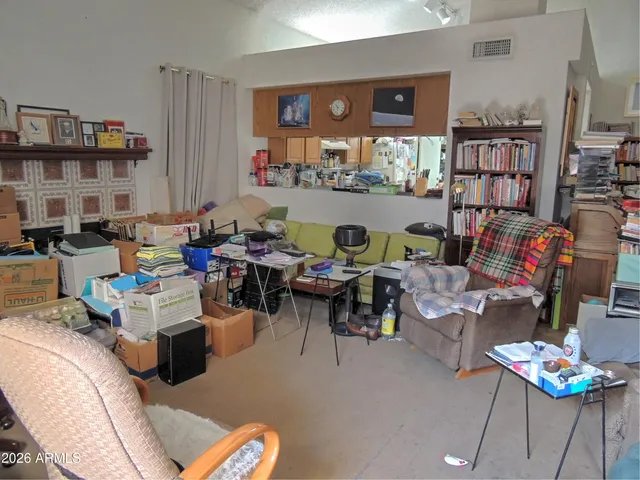 a work room with furniture and a book shelf