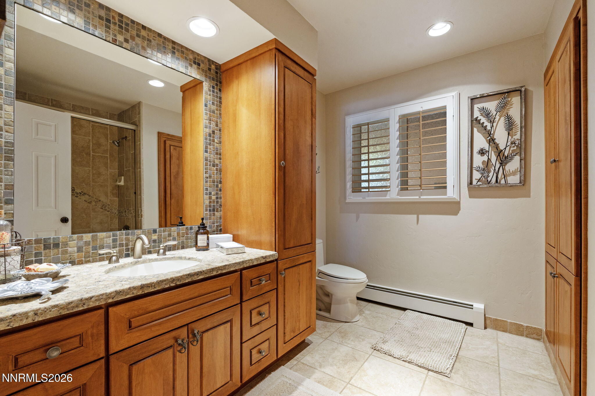 7850 Kevin Circle Reno, NV 89511 - Photo 30 of 68 a bathroom with a double vanity sink toilet and a mirror