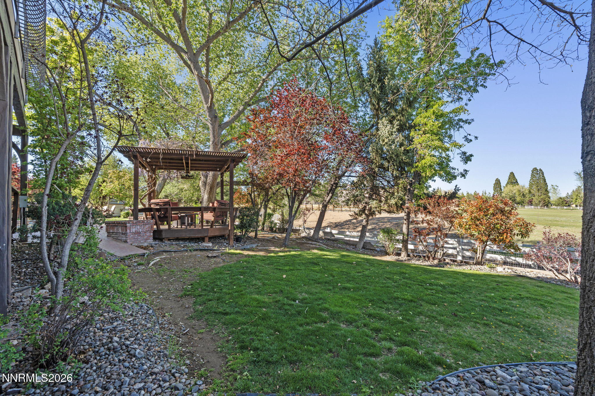 7850 Kevin Circle Reno, NV 89511 - Photo 53 of 68 a view of a backyard with table and chairs potted plants and large tree