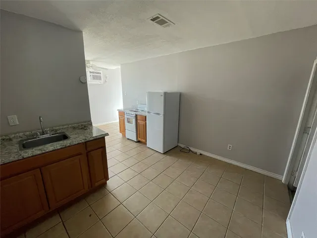 a kitchen with a sink and refrigerator