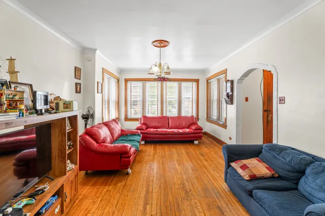 a living room with furniture and a chandelier