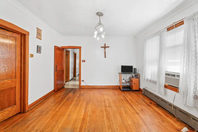 a view of a livingroom with wooden floor and a ceiling fan