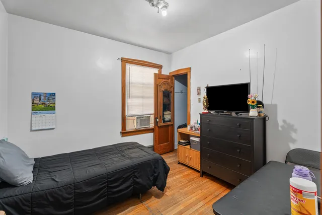 a bedroom with a bed and a television