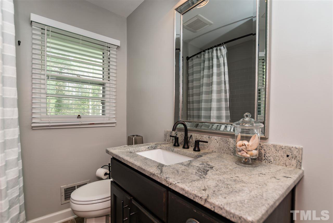 921 Cranbrook Road Raleigh, NC 27609 - Photo 14 of 25 a bathroom with a granite countertop sink toilet and mirror