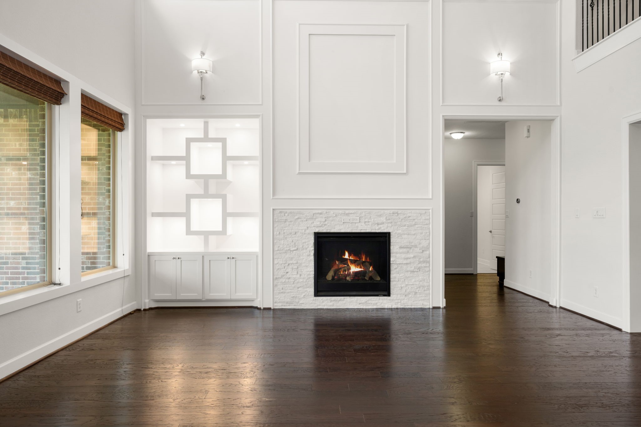 3622 Sage Hollow Drive Spring, TX 77386 - Photo 8 of 46 Relax by the stunning white stone fireplace surround, intricately detailed with full-wall white panel molding and a squared-off niche pre-wired with a concealed high-definition HDMI package for a seamless media layout.