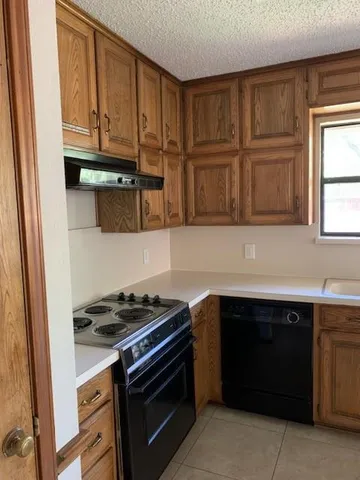 a kitchen with stainless steel appliances granite countertop a stove and a microwave