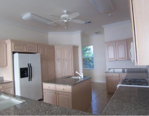 260 Southeast Cardinal Way Stuart, FL 34996 - Photo 6 of 8 a living room with furniture and a kitchen