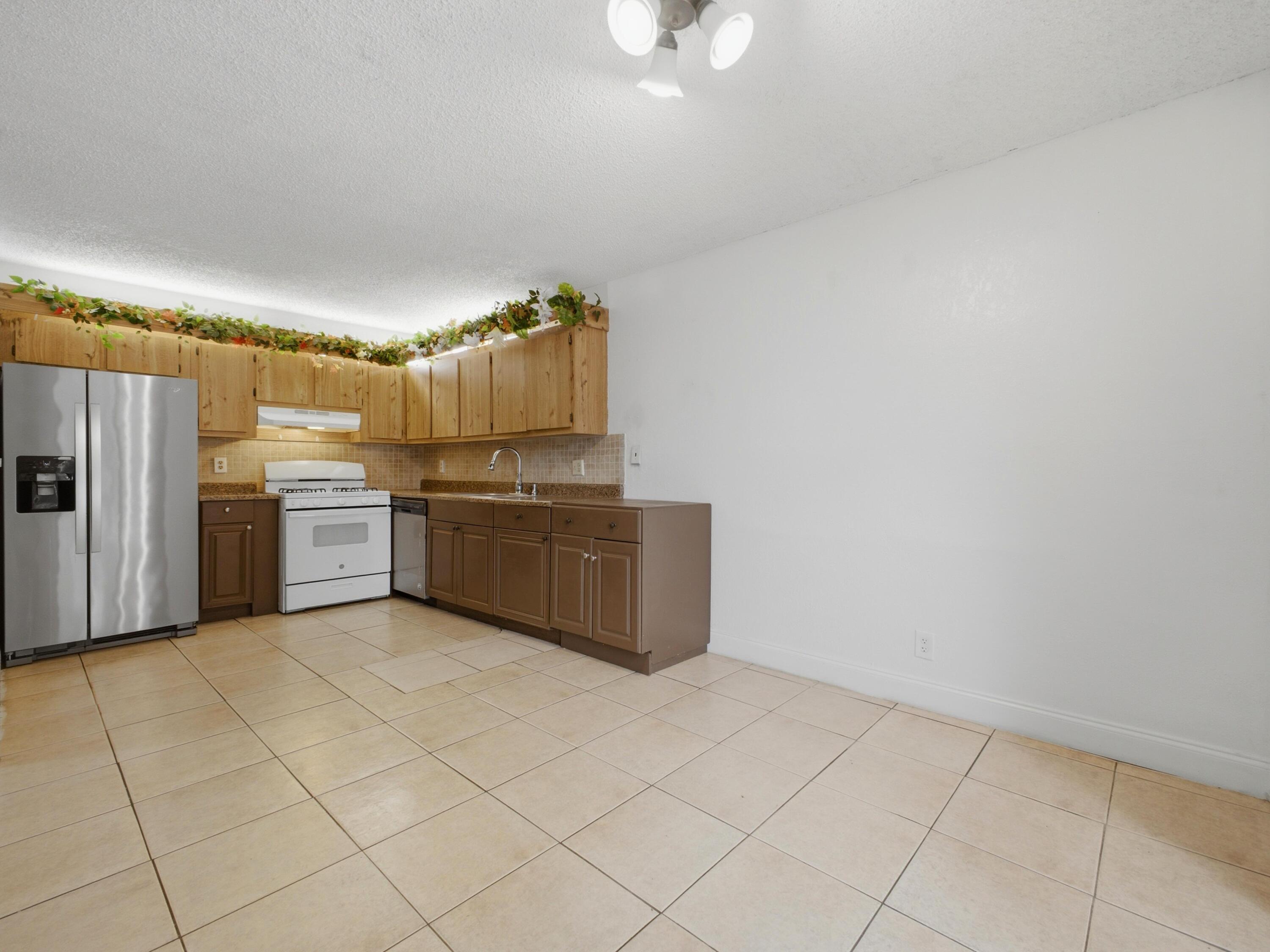 105 Woodland Road Palm Springs, FL 33461 - Photo 15 of 44 Dining to Kitchen