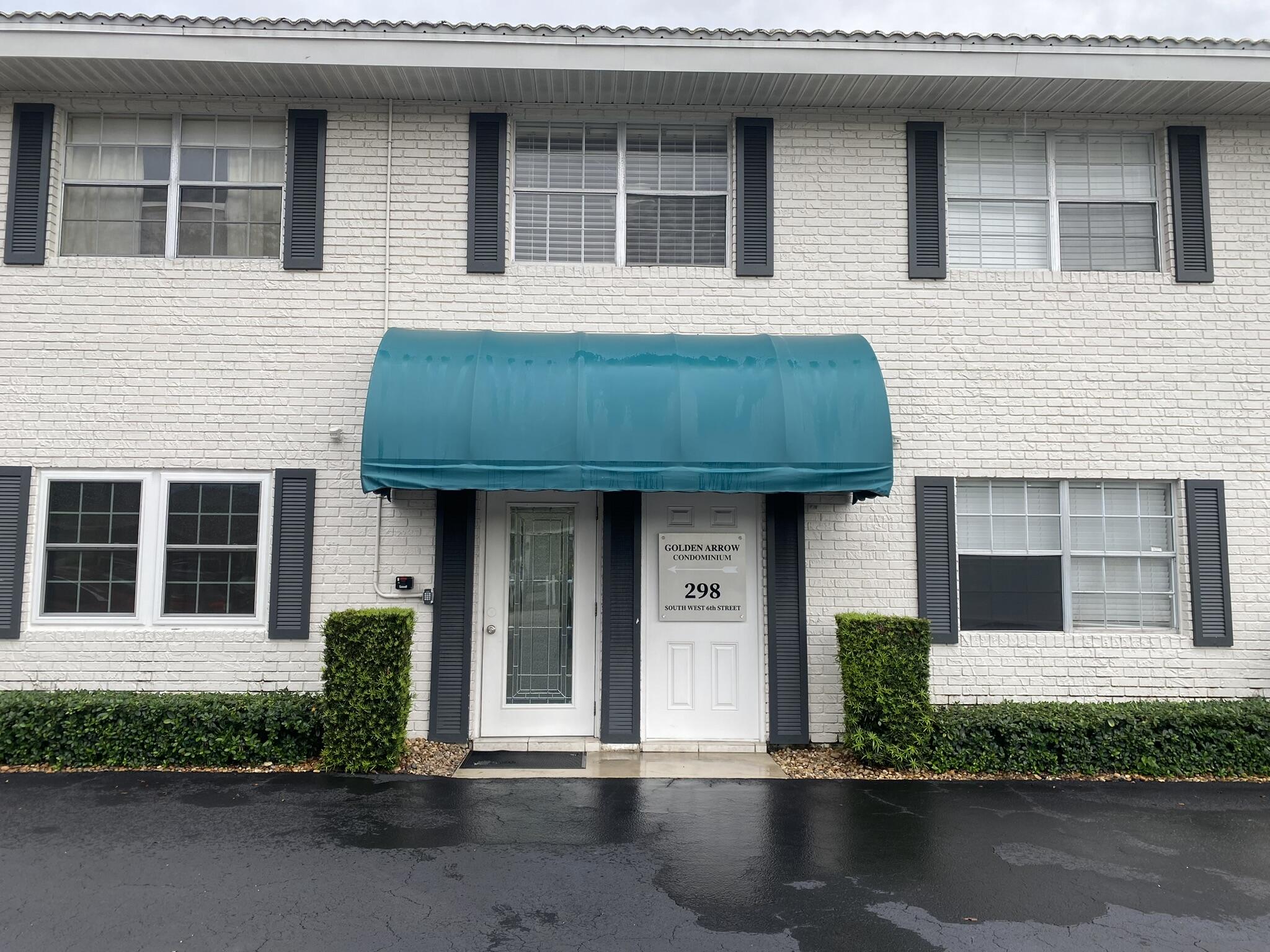298 Southwest 6th Street, Unit 109 Boca Raton, FL 33432 - Photo 1 of 28 a front view of a house with a garden