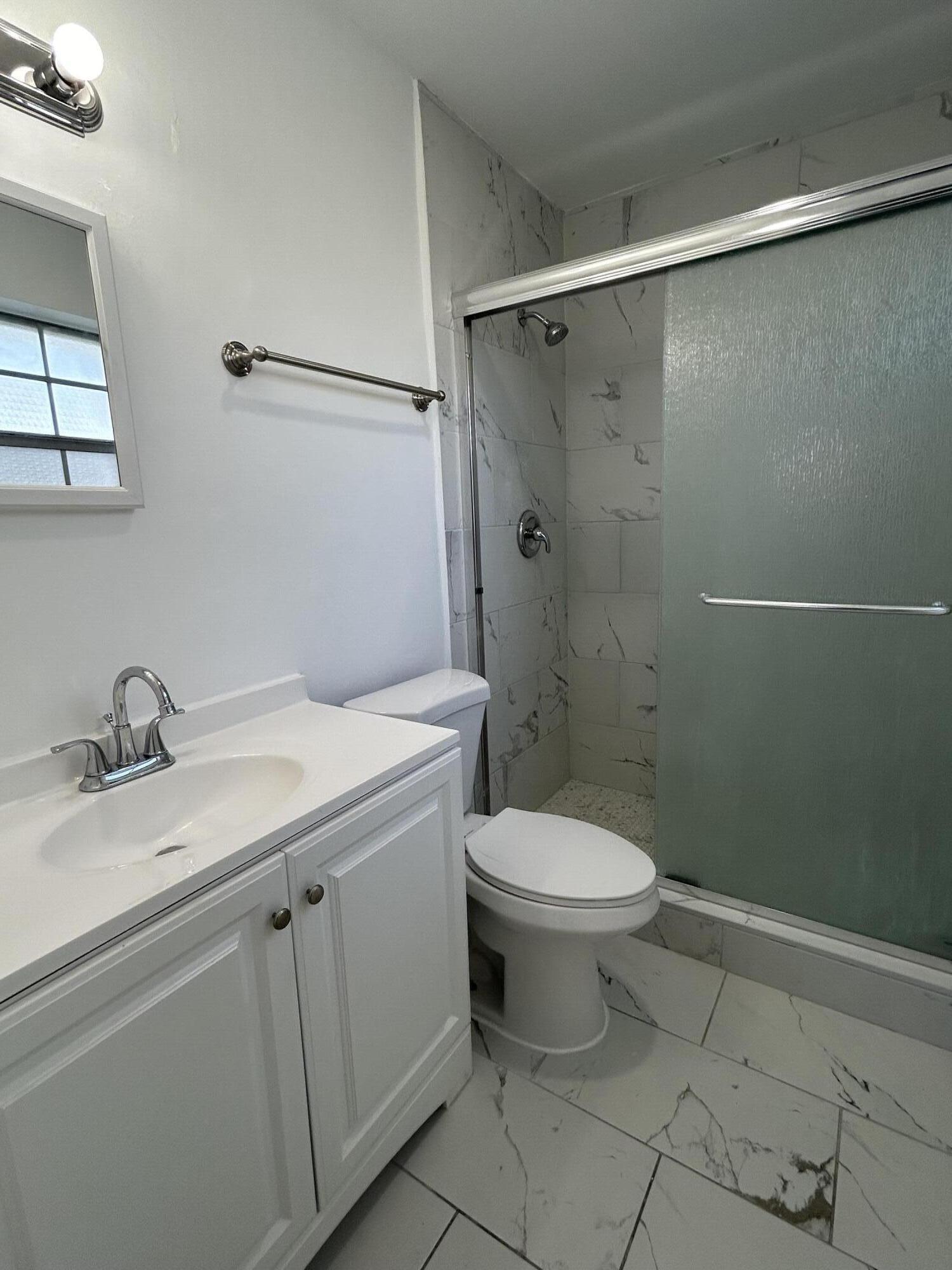 298 Southwest 6th Street, Unit 109 Boca Raton, FL 33432 - Photo 14 of 28 a bathroom with a sink toilet and shower