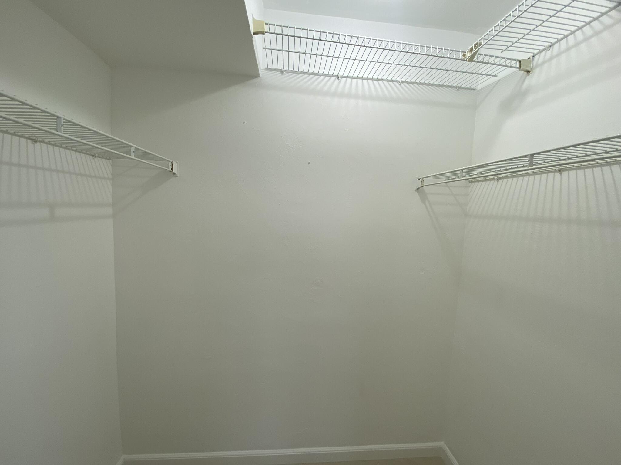 298 Southwest 6th Street, Unit 109 Boca Raton, FL 33432 - Photo 19 of 28 a view of a room with racks on the wall