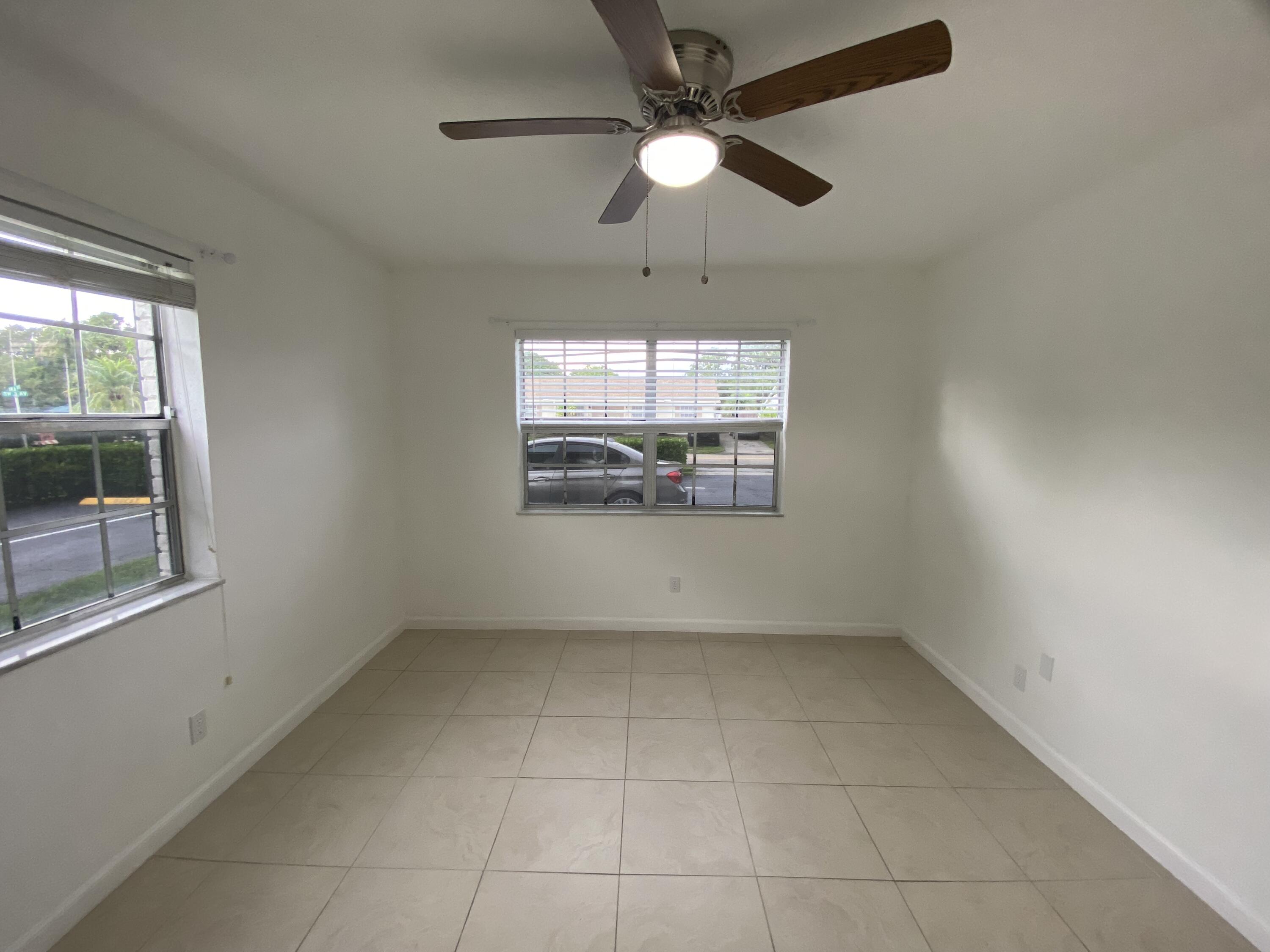 298 Southwest 6th Street, Unit 109 Boca Raton, FL 33432 - Photo 22 of 28 an empty room with windows and fan