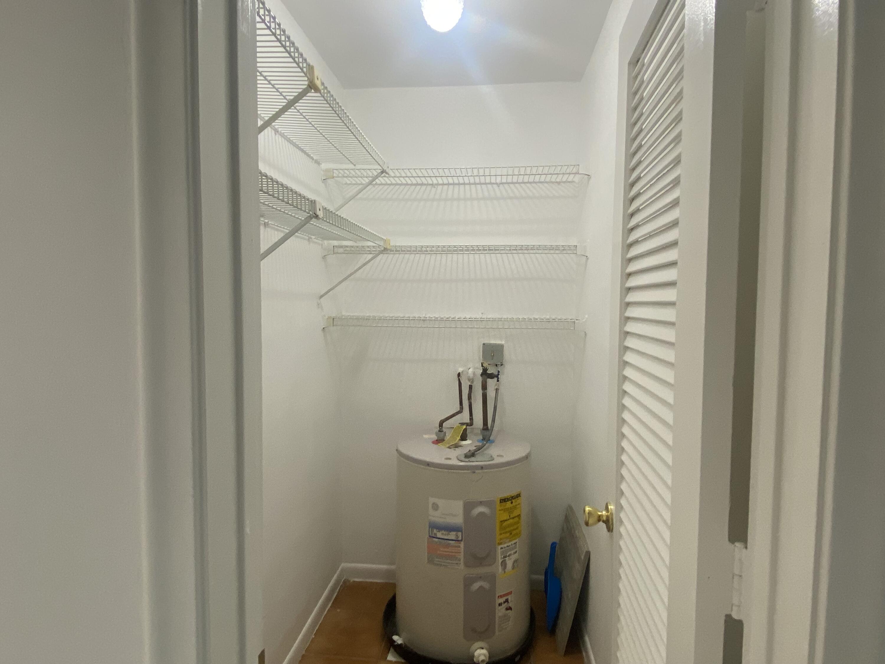 298 Southwest 6th Street, Unit 109 Boca Raton, FL 33432 - Photo 24 of 28 a bathroom with a sink and mirror