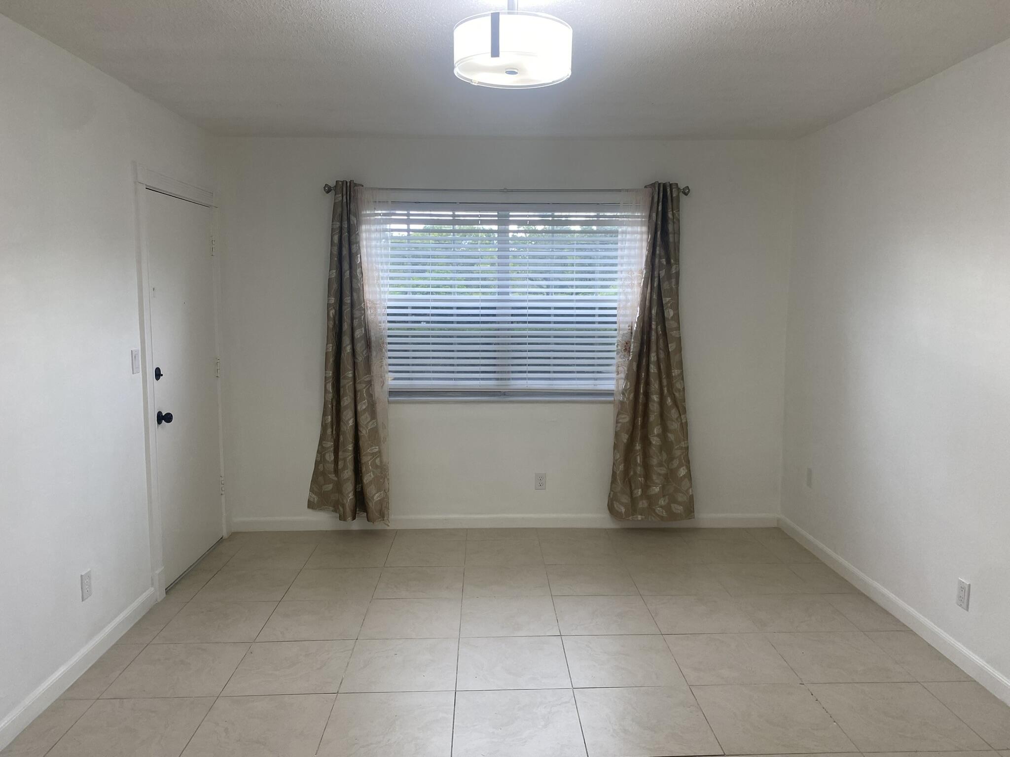 298 Southwest 6th Street, Unit 109 Boca Raton, FL 33432 - Photo 5 of 28 an empty room with window