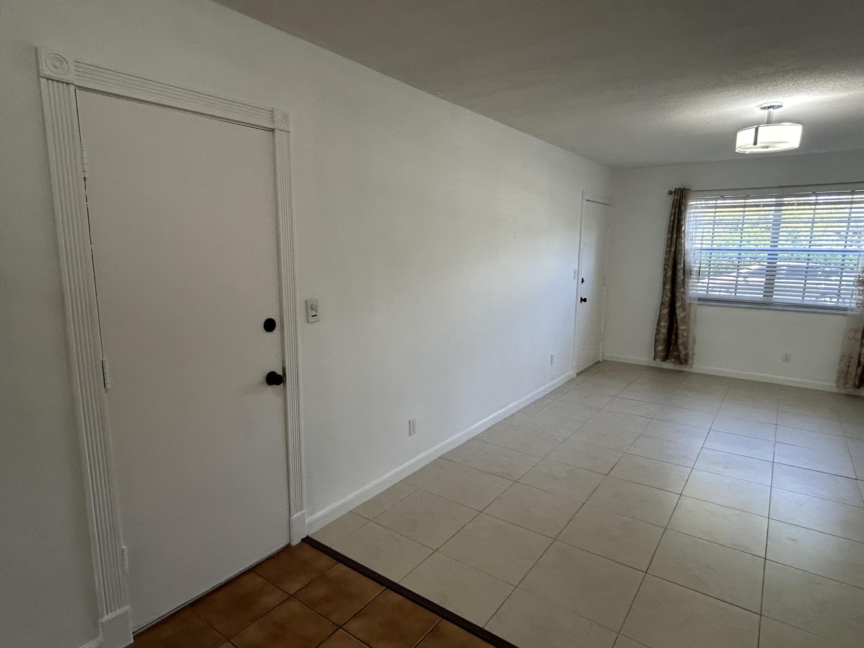 298 Southwest 6th Street, Unit 109 Boca Raton, FL 33432 - Photo 8 of 28 a view of an empty room and window