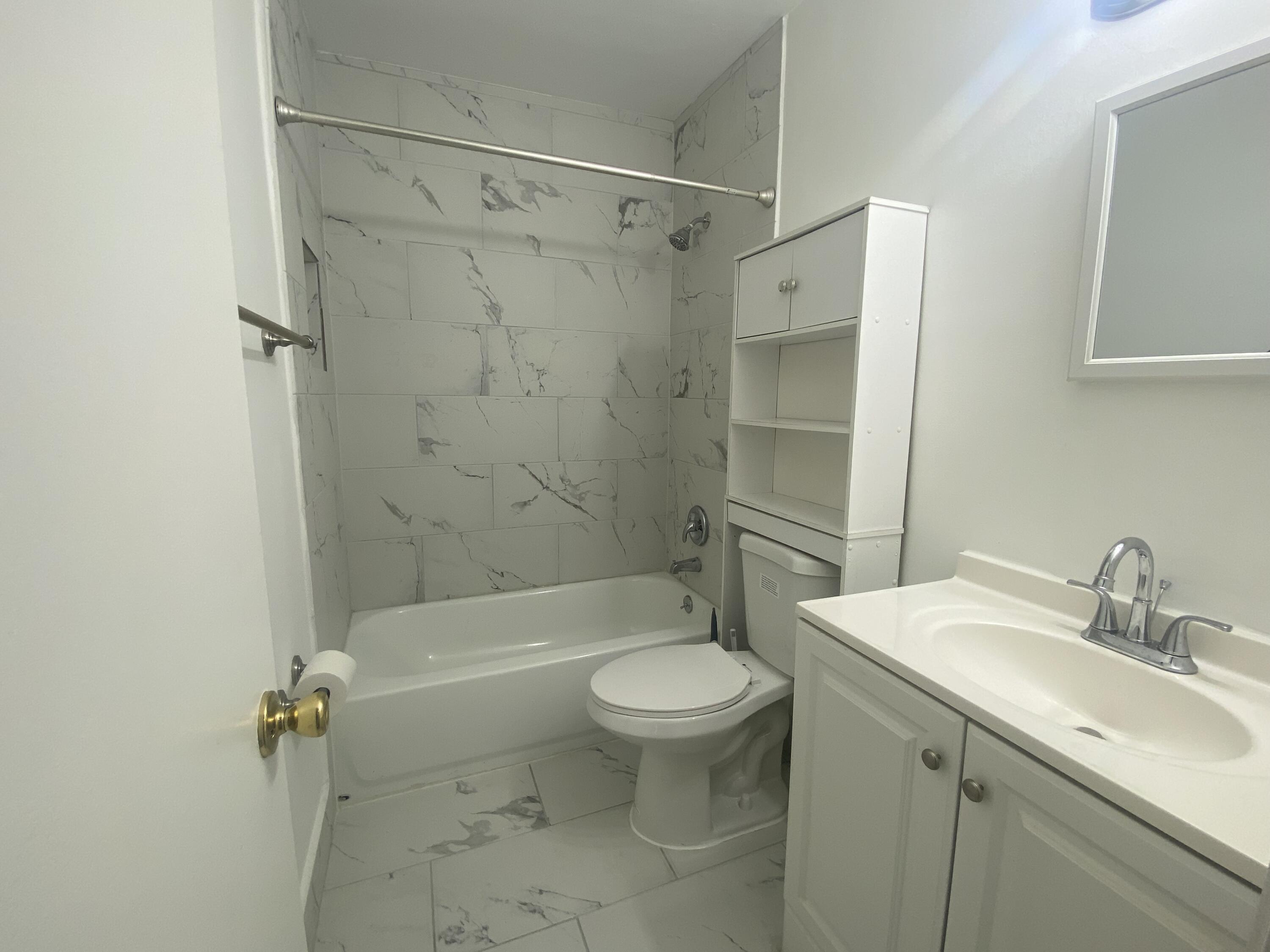 298 Southwest 6th Street, Unit 109 Boca Raton, FL 33432 - Photo 10 of 28 a bathroom with a sink toilet and shower