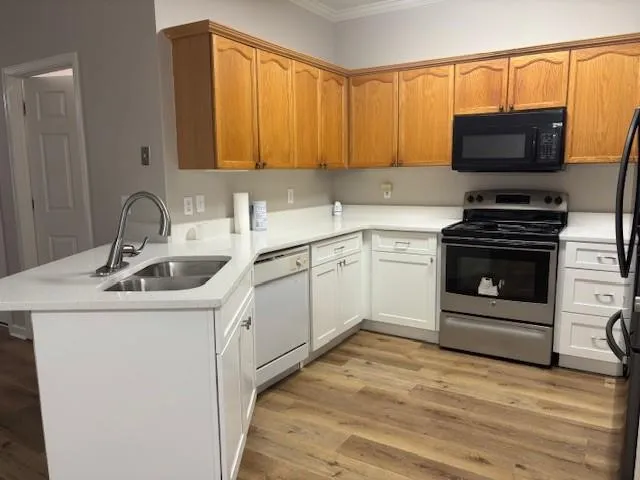 a kitchen with a sink and a stove top oven