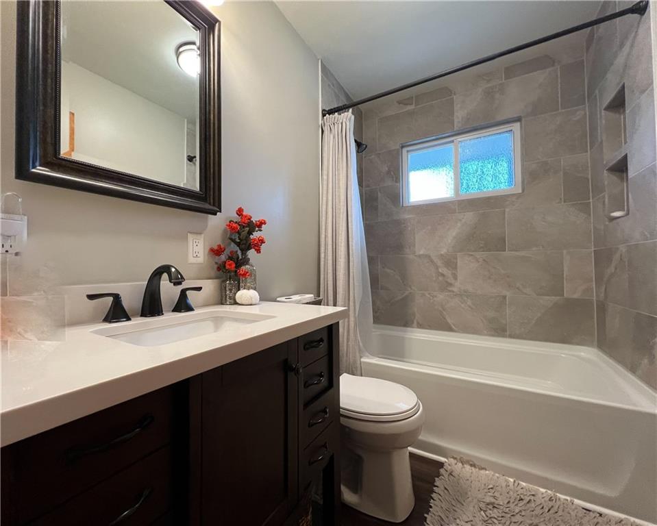 139 Delaware Drive Butler, PA 16001 - Photo 11 of 27 a bathroom with a bathtub shower sink mirror and toilet