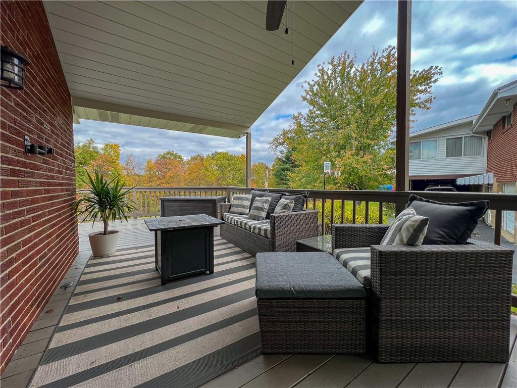 139 Delaware Drive Butler, PA 16001 - Photo 18 of 27 a view of a patio with couches chairs potted plants and floor to ceiling window with wooden floor
