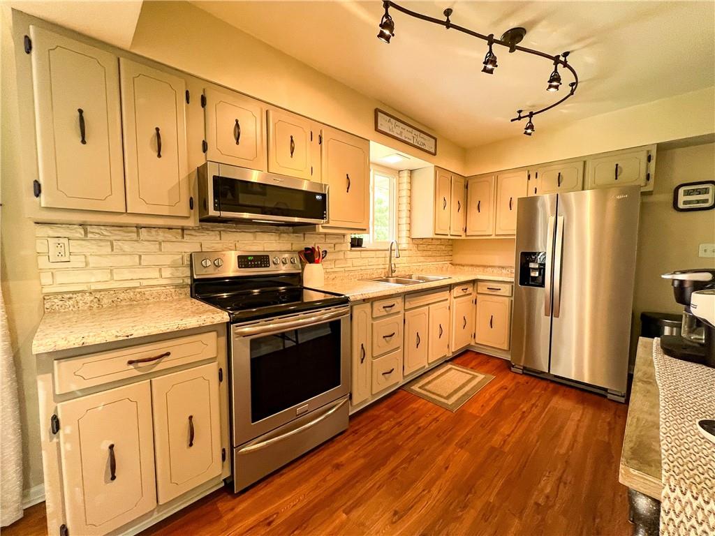 139 Delaware Drive Butler, PA 16001 - Photo 7 of 27 a kitchen with stainless steel appliances white cabinets a sink a stove a refrigerator and white cabinets