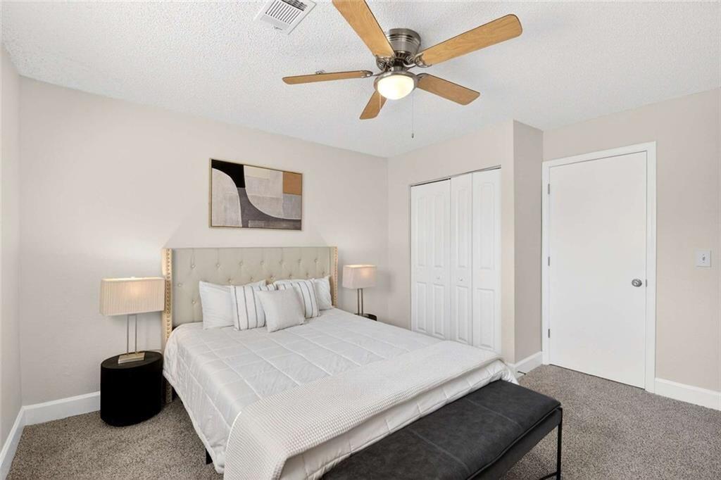 377 Ralph McGill Boulevard Northeast, Unit N Atlanta, GA 30312 - Photo 20 of 41 a bedroom with a bed and a lamp