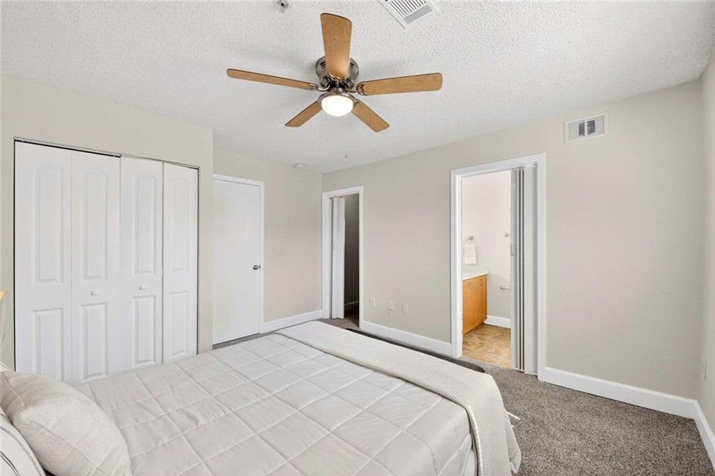 377 Ralph McGill Boulevard Northeast, Unit N Atlanta, GA 30312 - Photo 21 of 41 a bedroom with a bed and a chandelier