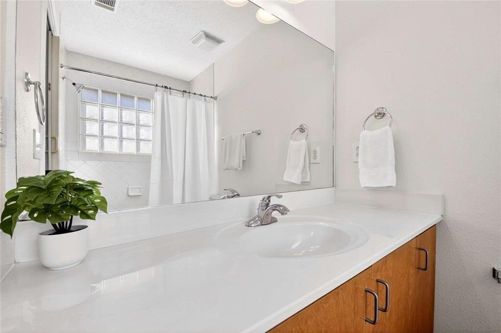 377 Ralph McGill Boulevard Northeast, Unit N Atlanta, GA 30312 - Photo 23 of 41 a bathroom with a sink and a mirror