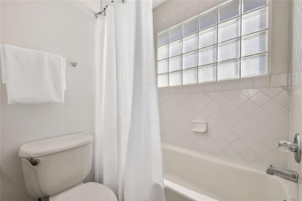 377 Ralph McGill Boulevard Northeast, Unit N Atlanta, GA 30312 - Photo 24 of 41 a bathroom with a toilet and bathtub