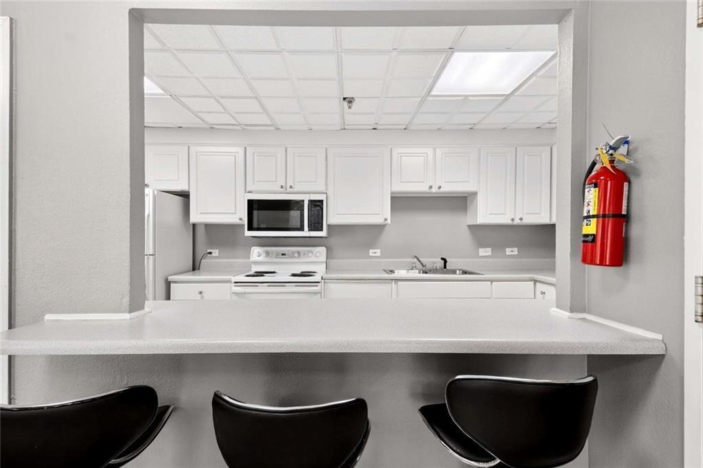 377 Ralph McGill Boulevard Northeast, Unit N Atlanta, GA 30312 - Photo 35 of 41 a kitchen with stainless steel appliances a sink a stove and a refrigerator