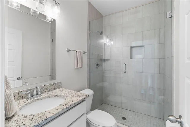 a bathroom with a sink toilet and shower