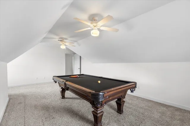 a room with wooden floor and fan
