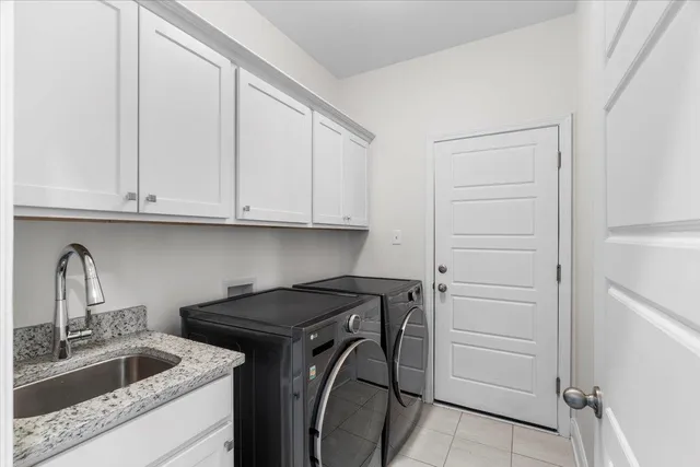 a view of a kitchen with white cabinets and a sink