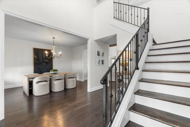 a view of a dining room with wooden floor and stairs