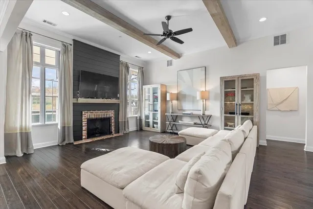 a large bedroom with furniture fireplace and a flat screen tv