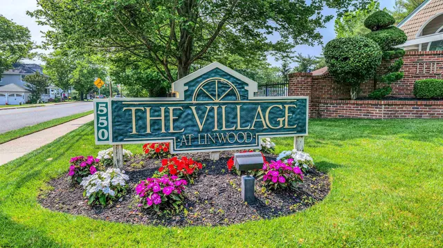 a sign that is in front of flowers