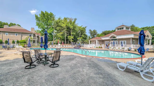 swimming pool view with a seating space